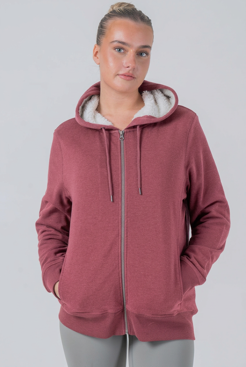 Dusty rose sherpa hoodie on model, studio shot