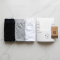 Flat-lay of black, grey and white underwear with Vistuba packaging
